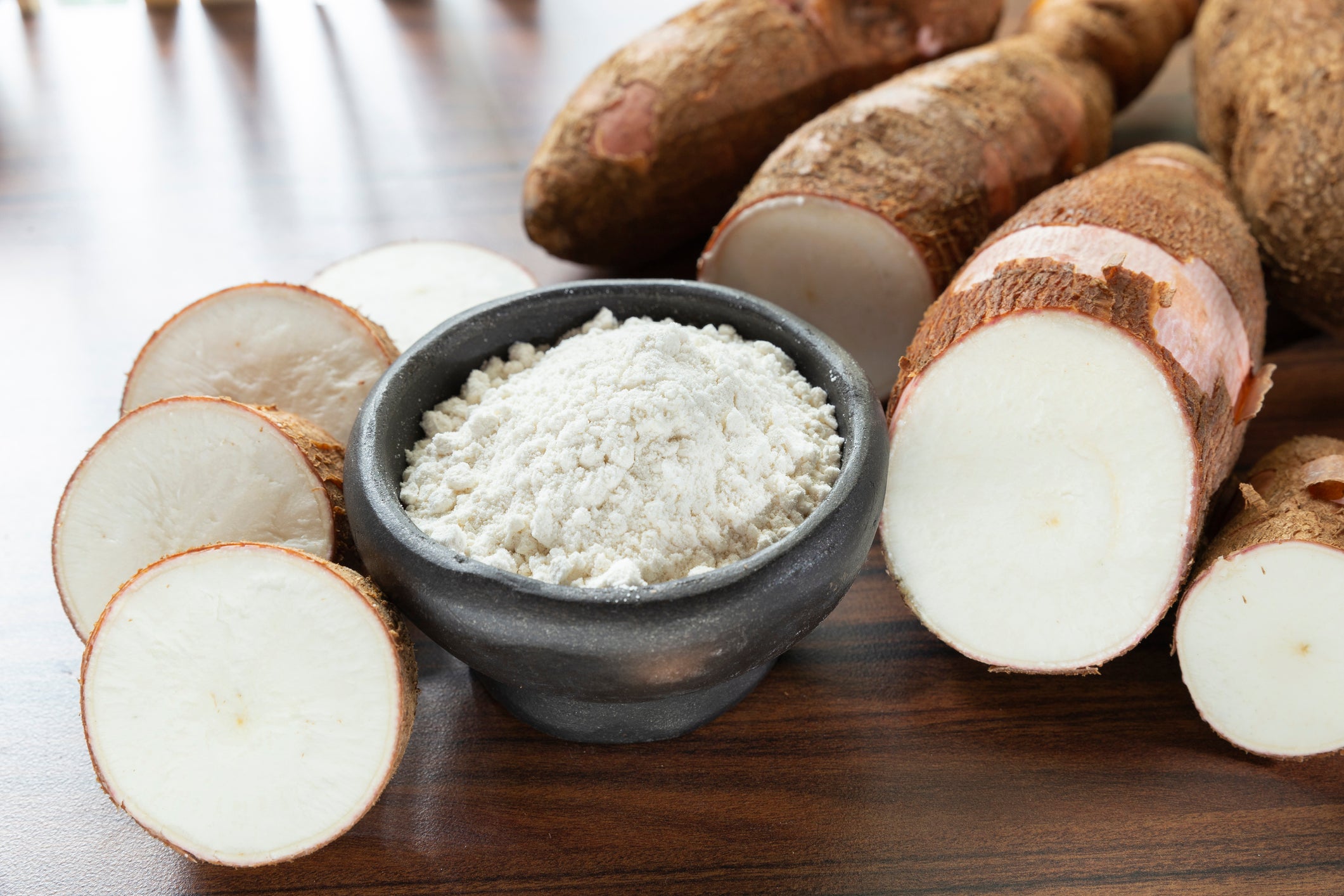 Raw yucca starch on the wooden table - Manihot esculenta..