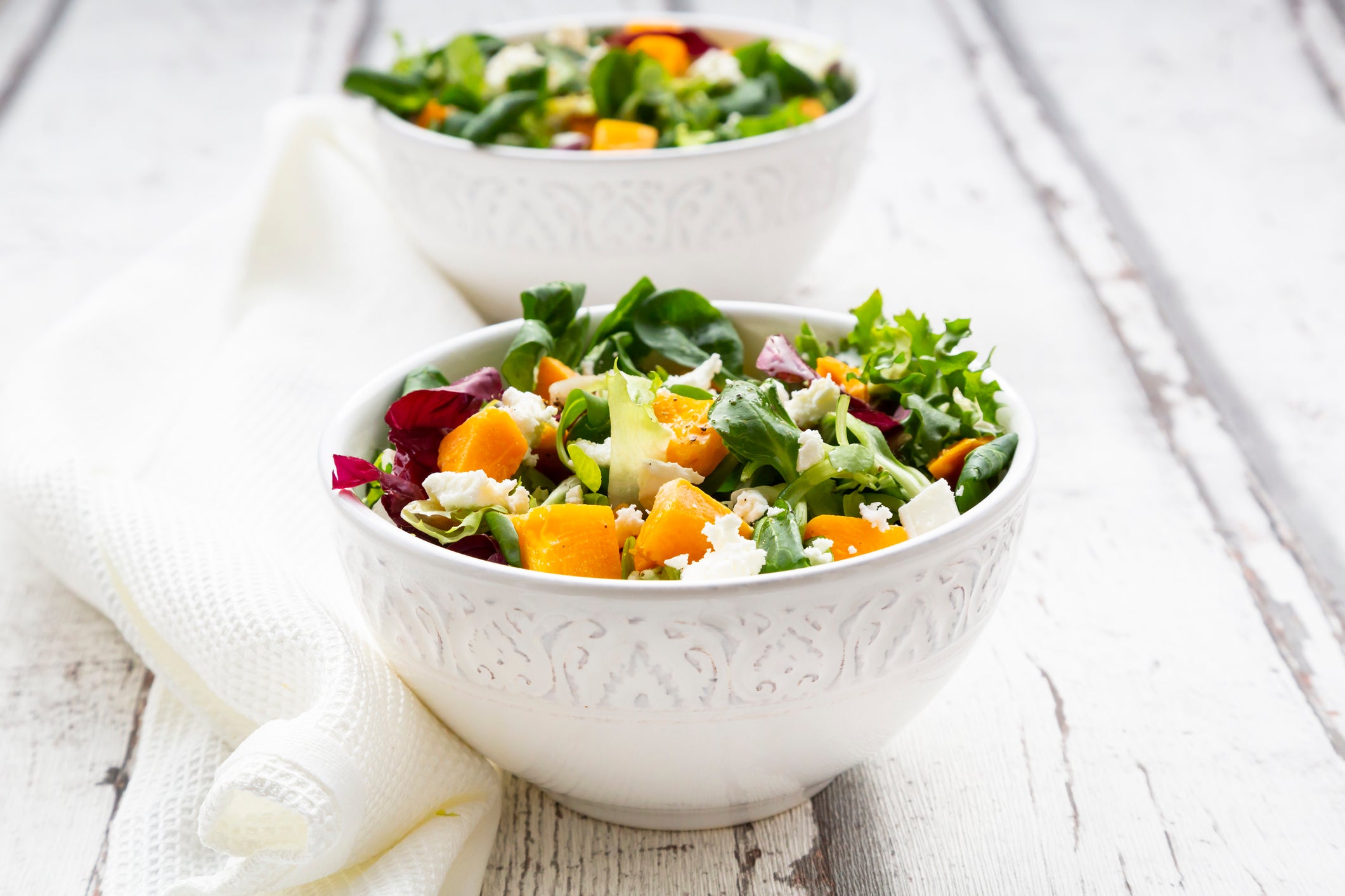 Bowls of autumnal salad with feta and Hokkaido pumpkin