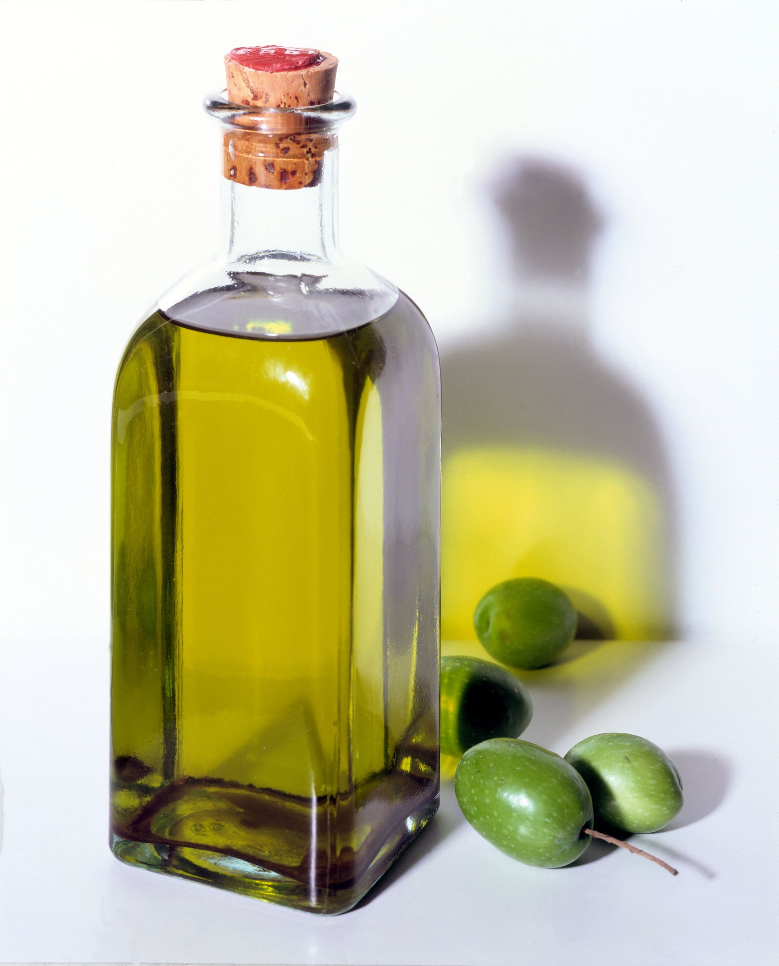 Bottle of olive oil with olives