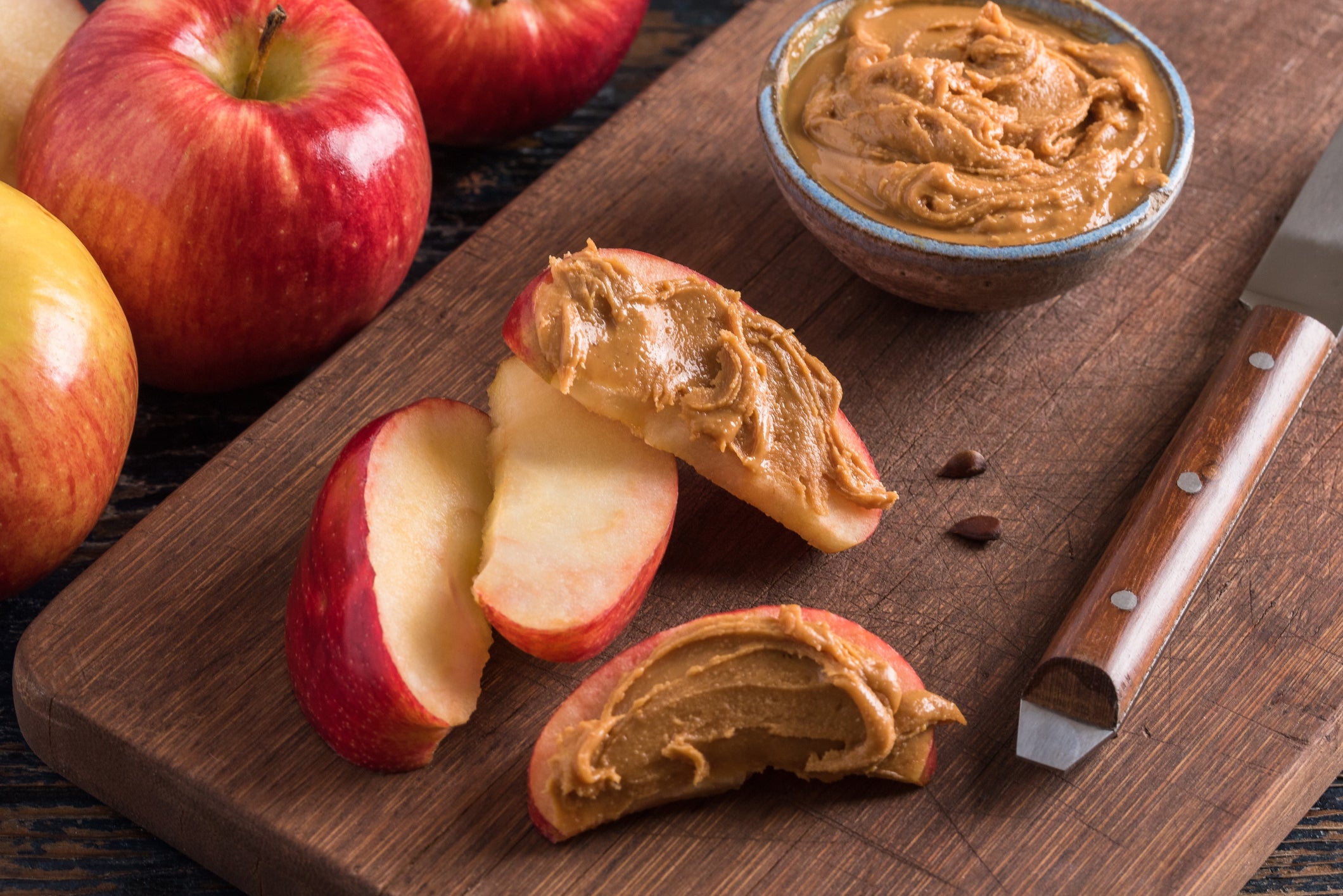 High Angle View Of Apple With Dip On Cutting Board