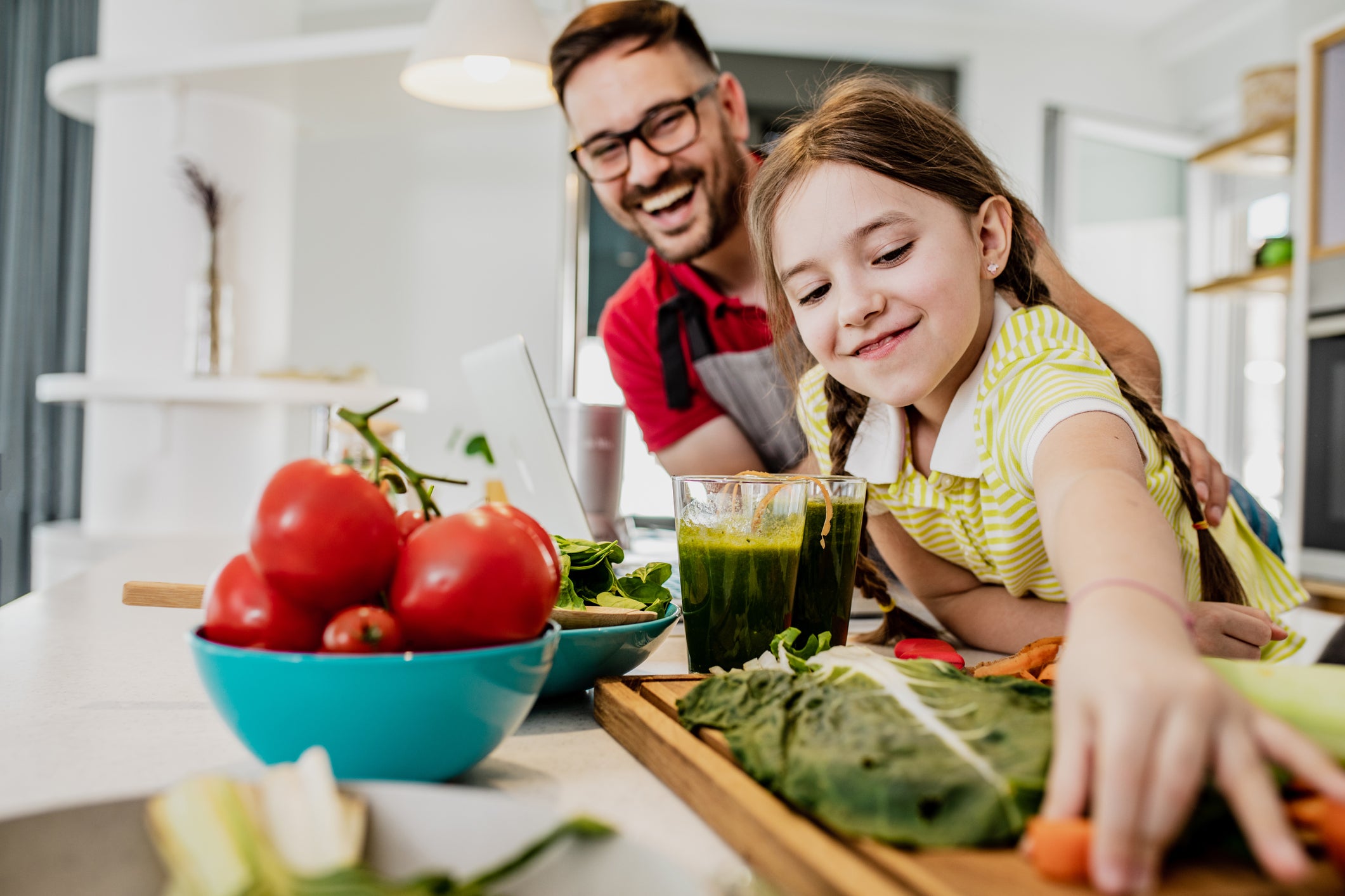 Father and his little cute daughter are cooking together