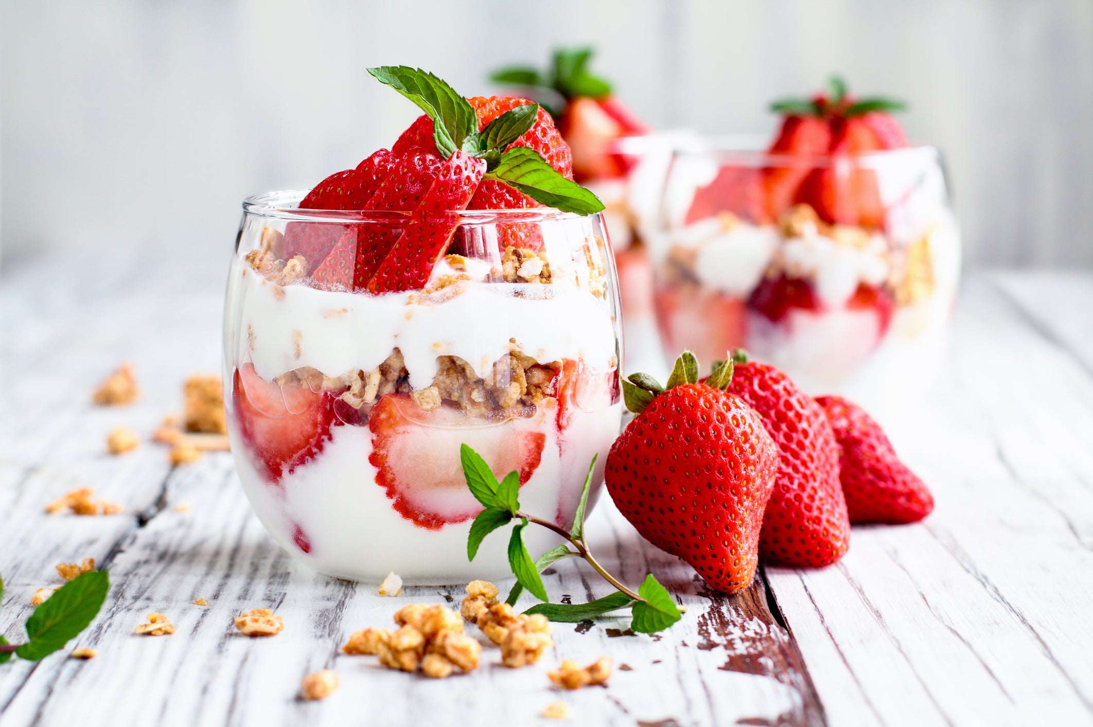 Healthy breakfast of strawberry parfaits made with fresh fruit, yogurt and granola