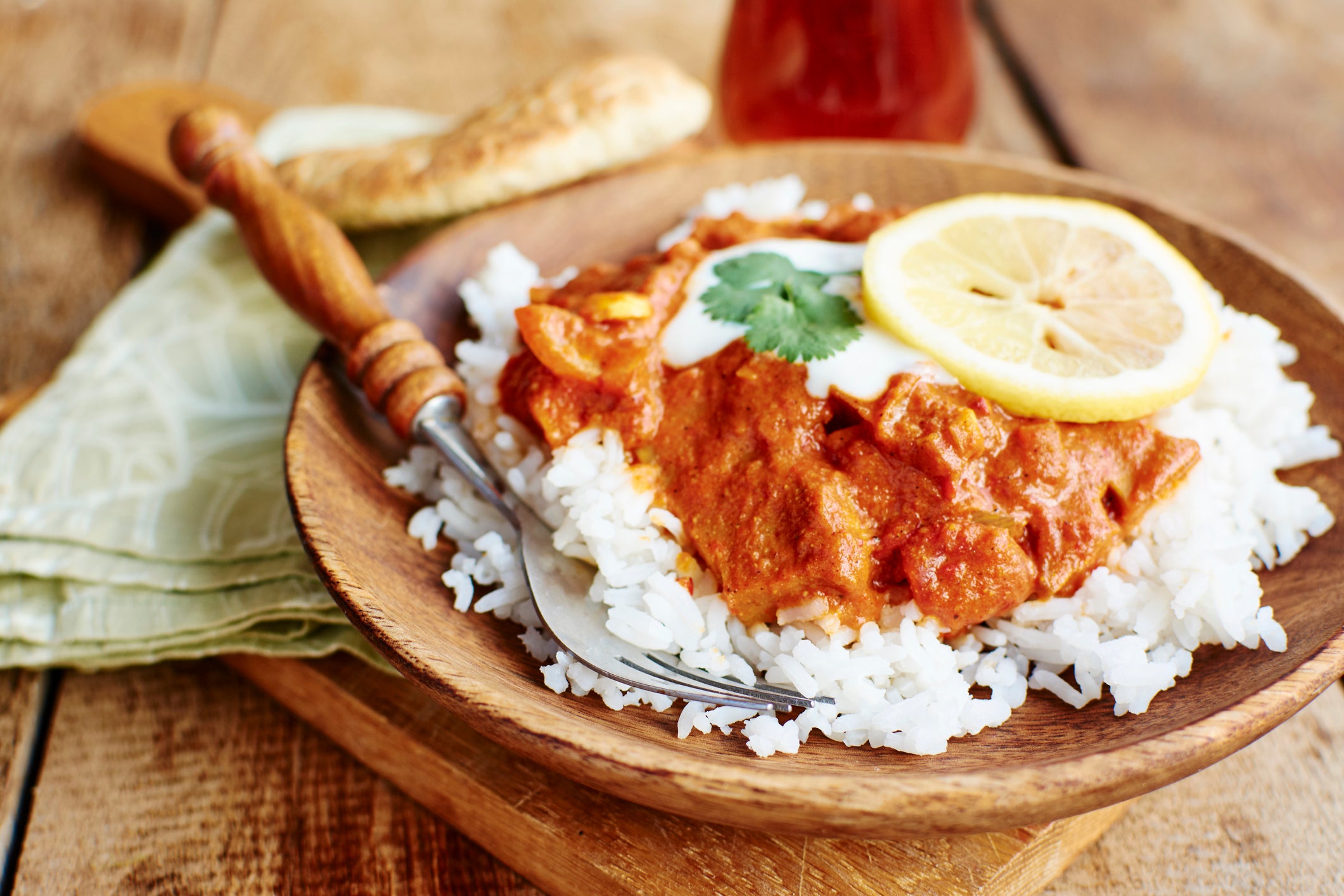 Seitan Tikka Masala on rice with soy yogurt and served with paratha bread