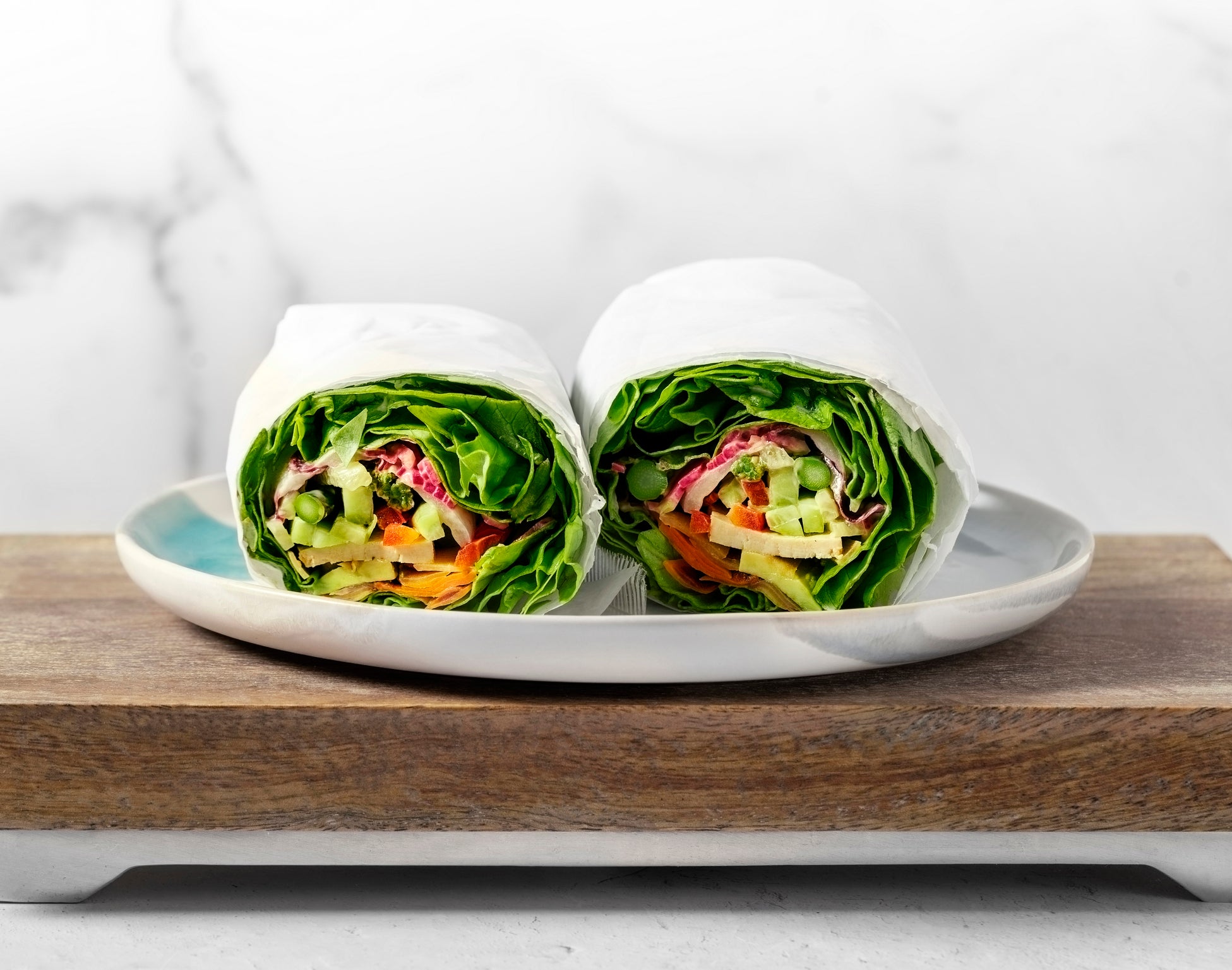 Healthy vegan wraps on a plate on white background