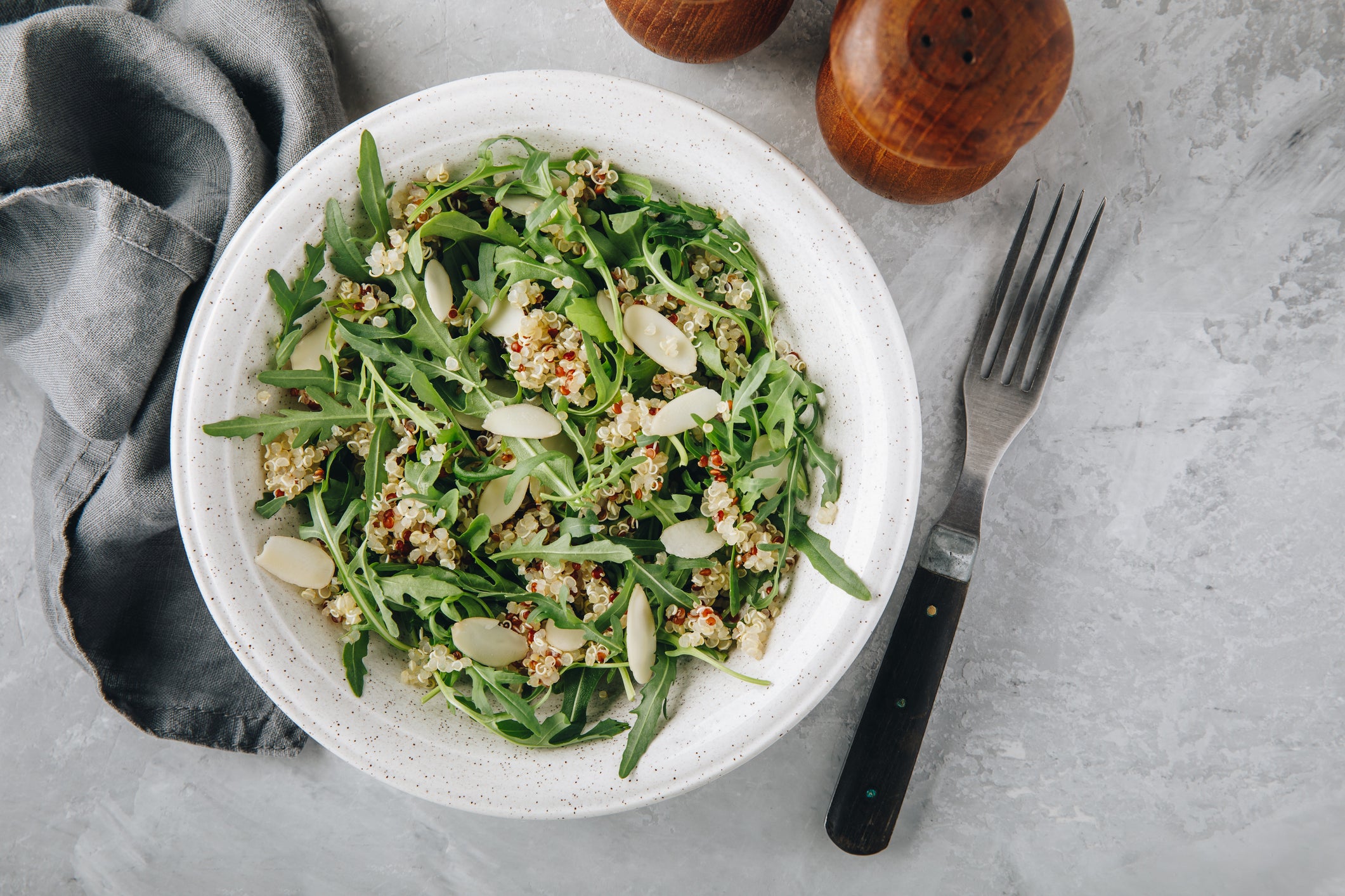 Quinoa salad with arugula and almonds. Vegetarian lunch bowl.