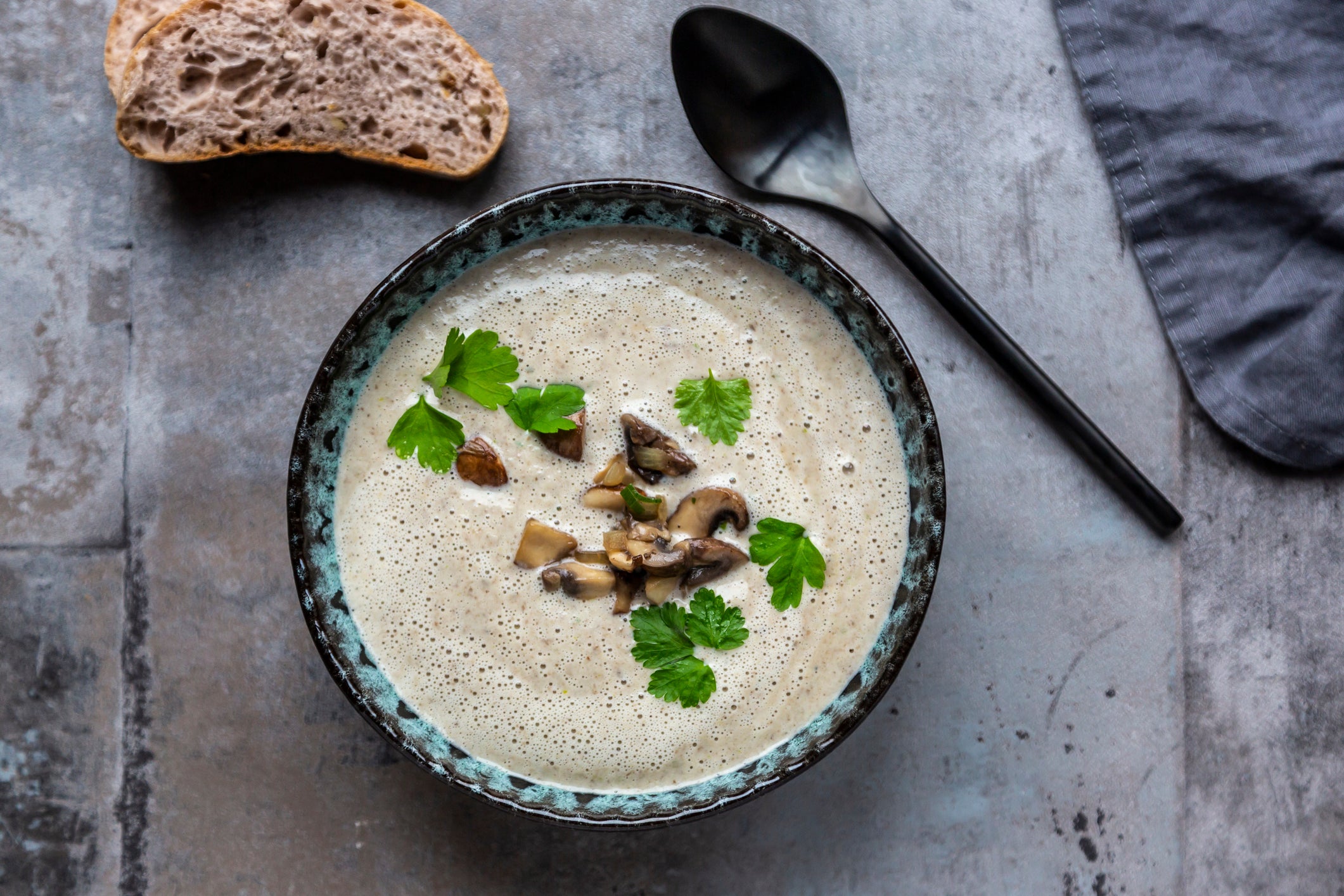 Creme of mushroom soup with cocosnut milk, parsley and baguette