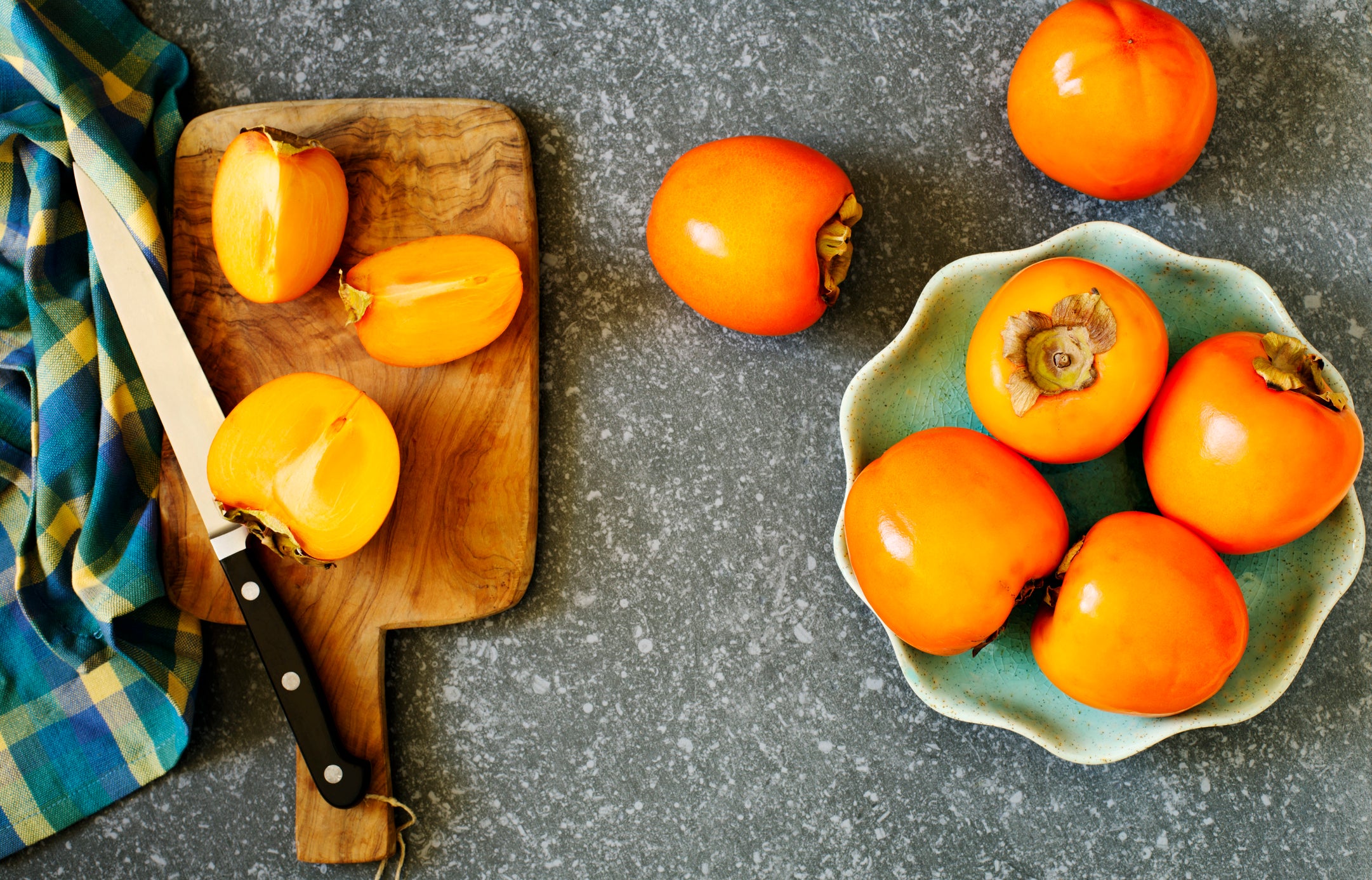 Delicious fresh persimmon fruits on table