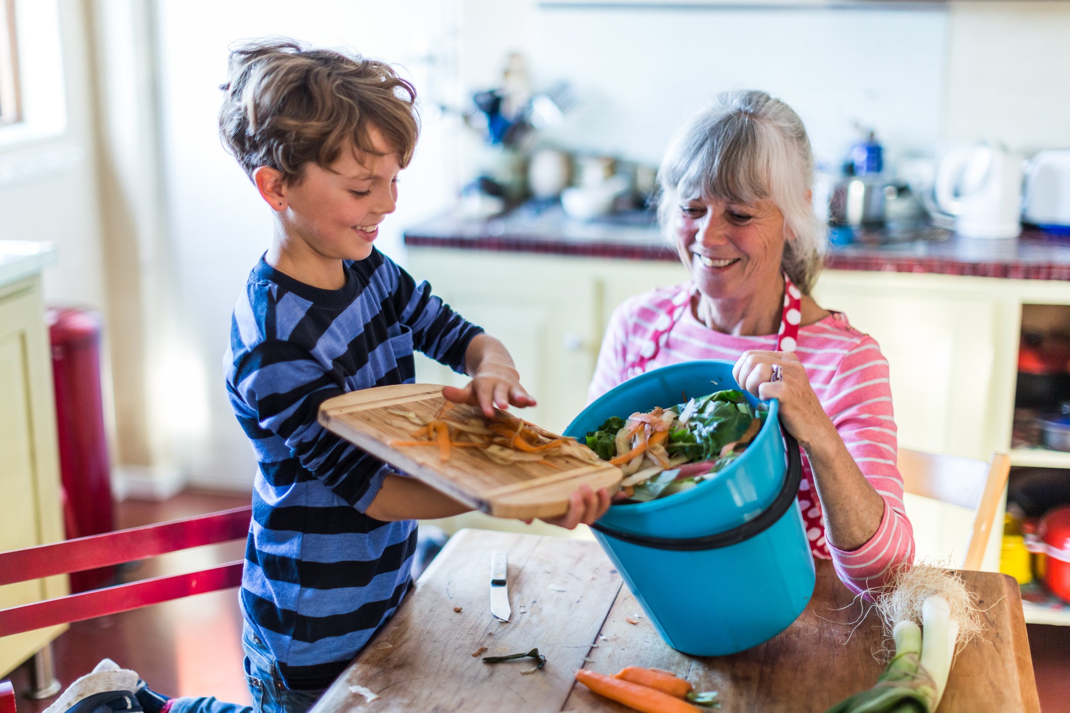 Grandson helping with kitchen waste for composting