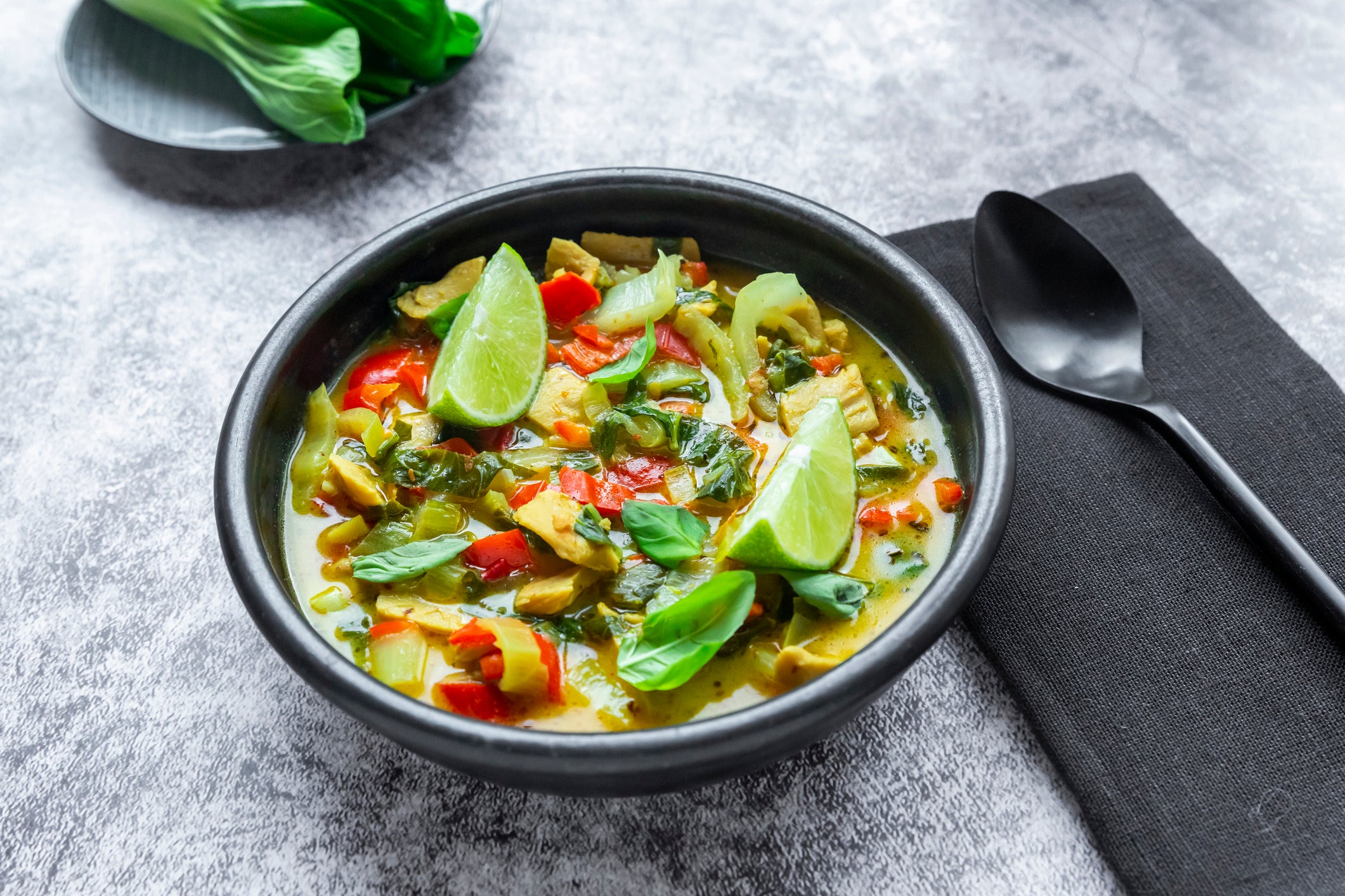 vegan curry soup with bok choy, red bell pepper and meat substitute